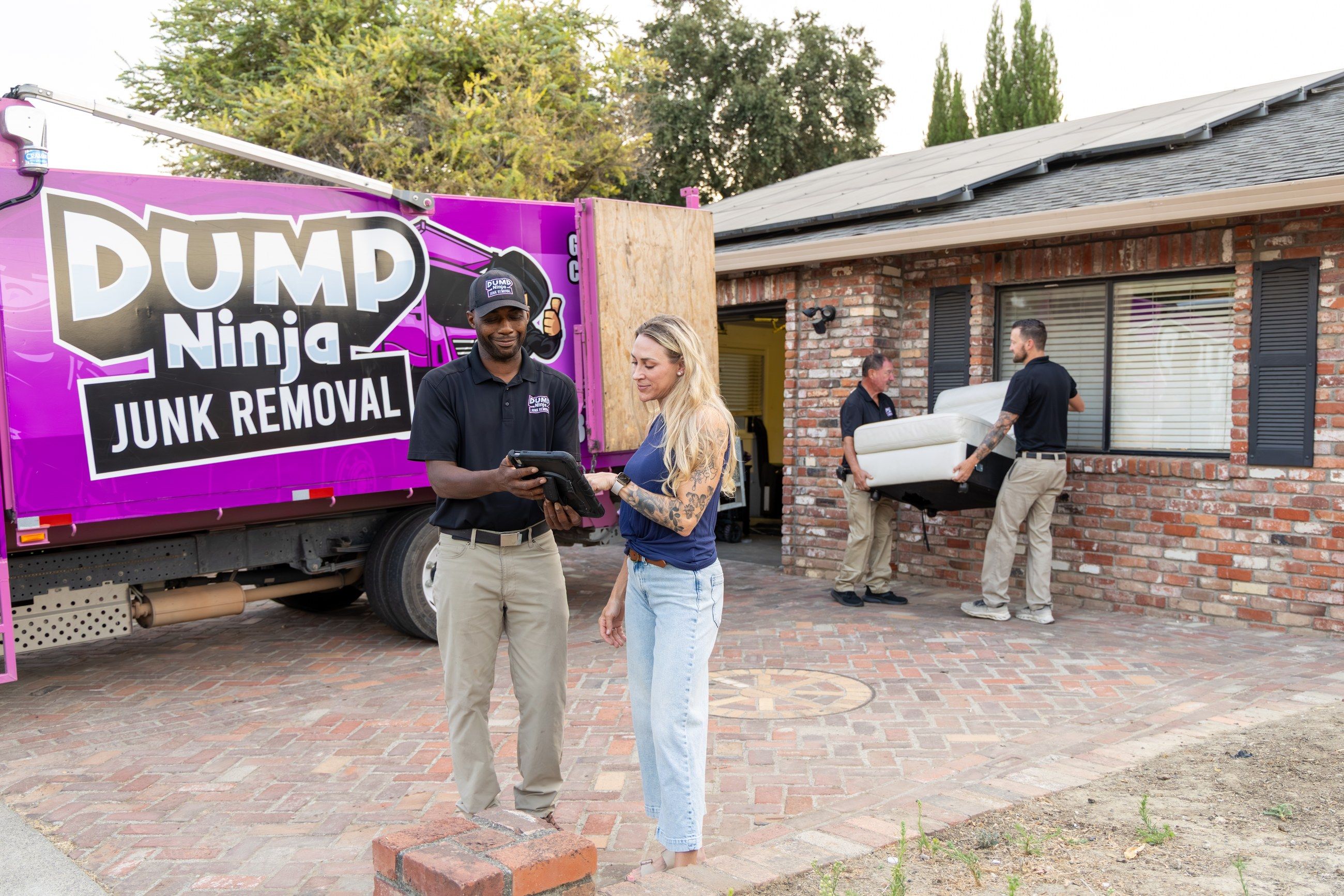 Dump Ninja crew and the magenta 21-yard truck at a Woodland home, going over the estimate with the homeowner